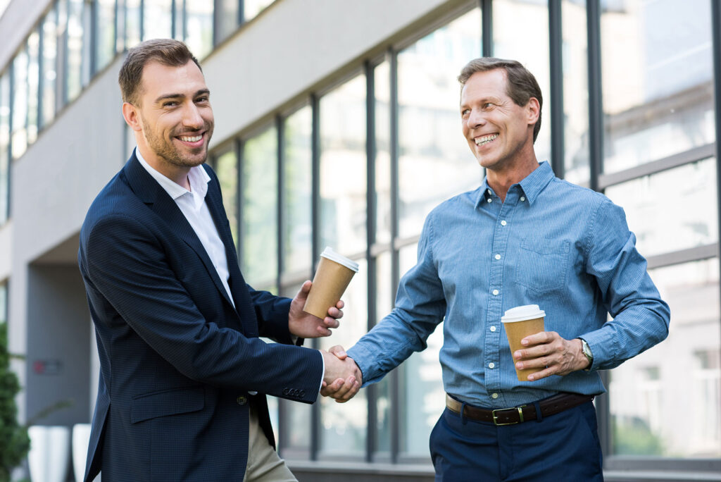 Smiling Businessmen With Disposable Cups Of Coffee 2023 11 27 05 30 13 Utc 2 1024x684